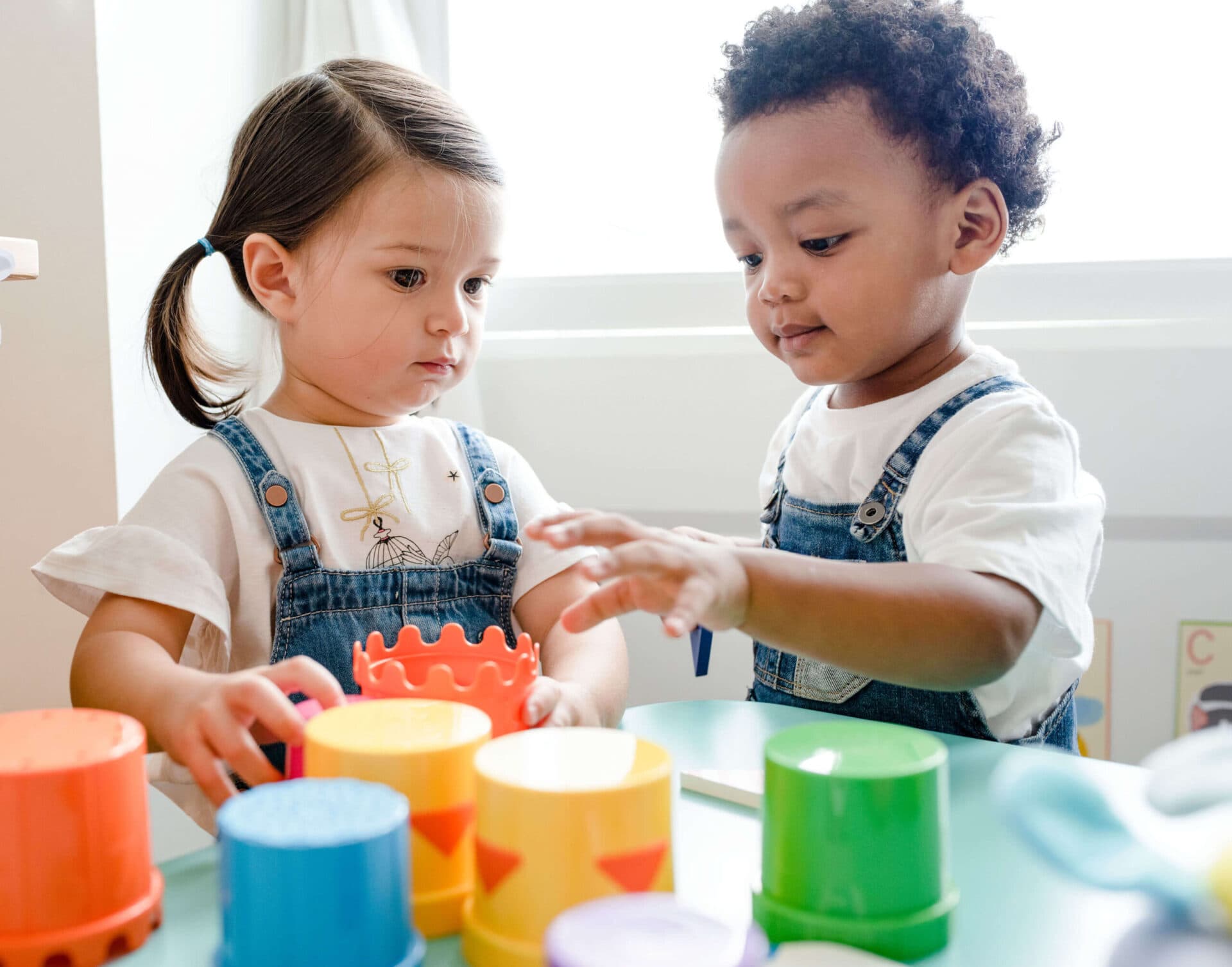 A teacher reading with children at Creative Playrooms